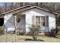 Charming home featuring a cozy front porch and a fenced yard, offering a blend of comfort and security at 309 Cody St, Durham, NC 27703