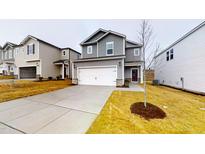 Charming two-story home with a spacious driveway and manicured front yard, showcasing modern architecture and curb appeal at 46 Coffee Tree Cir, Clayton, NC 27527