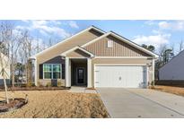 Charming single-story home featuring a well-manicured lawn and a convenient attached two-car garage at 504 Rhino Bnd, Oxford, NC 27565