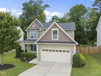 Charming two-story home with a well-manicured lawn and a two-car garage at 622 Lone Pine Loop, Fuquay Varina, NC 27526