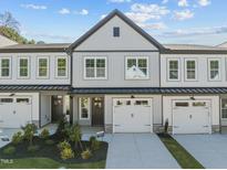 Charming townhome showcasing a welcoming facade with a private garage and manicured landscaping at 718 Jamescroft Way # 29, Rolesville, NC 27571