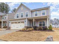 Charming two-story home featuring a two-car garage and covered front porch at 121 Mason Oaks Dr, Wake Forest, NC 27587