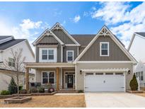 Charming two-story home featuring a welcoming front porch and a two-car garage at 1530 Armscroft Ln, Apex, NC 27502