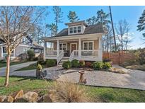 Charming home showcasing a welcoming front porch, stylish landscaping, and a well-maintained exterior at 2505 Francis St, Durham, NC 27707