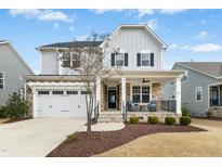 Charming two-story home with stone accents, a covered porch, and an attached two-car garage at 26 Stone Bridge Xing, Chapel Hill, NC 27517