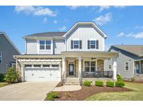 Charming two-story home with stone accents, covered porch, attached garage, and well-maintained landscaping at 26 Stone Bridge Xing, Chapel Hill, NC 27517