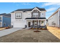 Beautiful two-story home with stone accents, covered porch, and well-manicured lawn in a Gathering-friendly neighborhood at 335 North Maple Walk Dr # 212, Garner, NC 27529