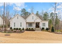 Charming home featuring a well-manicured lawn, welcoming front porch and classic architectural details at 396 Stonecrest Way, Pittsboro, NC 27312