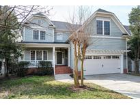 Charming two-story home with a welcoming front porch and a well-maintained lawn, perfect for curb appeal at 500 Chandler Grant Drive Dr, Cary, NC 27519