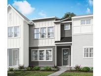 Charming two-story townhome featuring a well-maintained lawn and neutral colored siding at 602 Hyperion Aly, Wake Forest, NC 27587