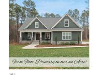 Charming single-story home with a beautifully landscaped front yard and a welcoming covered porch at 85 Willow Bend Dr, Youngsville, NC 27596