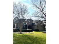 Traditional brick home with well-manicured lawn and landscaping, complemented by mature trees and an attached garage at 101 Tussled Ivy Way, Cary, NC 27513