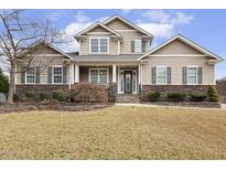 Charming two-story home with stone accents, neutral siding, and a well-manicured lawn at 115 Vintage Hill Cir, Apex, NC 27539