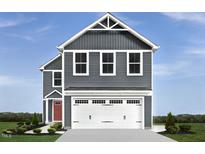 Charming two-story home with gray siding and a spacious two-car garage at 133 Cavalier Rider Run, Wendell, NC 27591