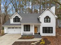 Beautiful two-story home boasting black-framed windows, a covered porch, and a two-car garage at 202 Oxford Hills Dr, Chapel Hill, NC 27514