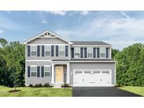 Charming two-story home with gray siding, black shutters, and a two-car garage at 265 Day Farm Dr, Lillington, NC 27546