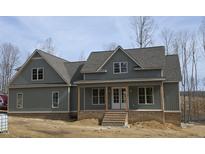 Charming gray two-story home with brick foundation and inviting front porch at 2833 Faucette Ln, Burlington, NC 27217