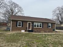 Charming brick home featuring a well-maintained yard and inviting entrance at 300 W Carr St, Mebane, NC 27302