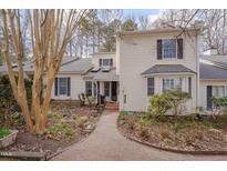 Charming two-story home with a brick pathway and partially wooded front yard landscape at 360 Linden Close, Pittsboro, NC 27312