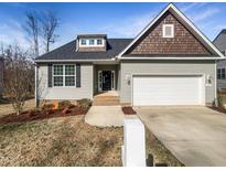 Charming single-story home featuring a two-car garage, landscaped yard, and traditional architectural details at 480 Stonewall Dr, Mebane, NC 27302