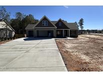 New construction home with a spacious driveway and a charming craftsman-style facade at 100 Spumante Ct, Princeton, NC 27569