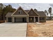 Inviting two-story home with a three-car garage and stone accents in a well-developed community at 100 Spumante Ct, Princeton, NC 27569