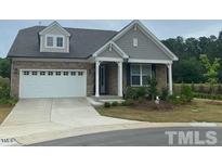 Charming single-story home featuring a stone facade, two-car garage, and well-maintained landscaping at 1006 Pondfield Way, Durham, NC 27713
