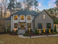 Stunning two-story home with a stone facade, manicured landscaping, and a welcoming entrance at 1012 Casa Dega Way, Raleigh, NC 27613