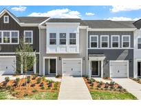 Charming townhomes with attached garages, professionally landscaped yards, and neutral color schemes at 116 Central Townes Way # 293, Raleigh, NC 27603