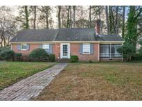 Charming single-story brick home with a brick walkway, inviting curb appeal, and mature trees at 127 Wilkinson St, Rocky Mount, NC 27804