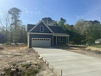 New construction home featuring a gray exterior, two-car garage, and a concrete driveway at 162 Kirkwall Ln, Selma, NC 27576