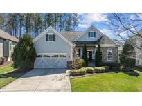 Charming two-story home featuring a well-manicured lawn, attached two-car garage, and lovely landscaping at 1637 Hasentree Villa Ln, Wake Forest, NC 27587
