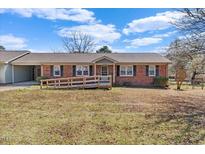 Charming single-story brick house with a ramp, front yard, and mature landscaping at 200 Barwick Way, Knightdale, NC 27545