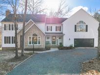 Charming two-story home with a well-manicured lawn and inviting front porch at 2107 Spring Ln, Sanford, NC 27330