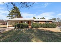 Charming brick home with a covered carport and well-maintained landscaping at 2311 Glover Rd, Durham, NC 27703