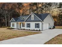 Charming home with a manicured lawn, elegant architectural details, and a spacious driveway at 3328 Leaflet Church Rd, Broadway, NC 27505