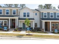 Charming exterior view of townhomes showcases unique architectural details and inviting entryways at 3717 Rosebush Dr, Zebulon, NC 27597