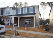 New two-story home with brick facade, shingle siding, and white columns, still under construction at 3719 Rosebush Dr, Zebulon, NC 27597