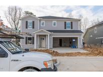 Two-story home with gray siding, white trim, and a two-car garage, in construction stage at 3825 Rosebush Dr, Zebulon, NC 27597