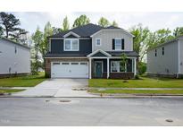 Beautiful two-story home with a two-car garage, neutral colors, and well-maintained lawn at 3829 Rosebush Dr, Zebulon, NC 27597