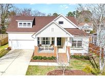 Charming two-story home boasts a brick front porch and attached garage at 404 Regulators Way, Hillsborough, NC 27278