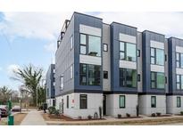 Modern townhome exterior featuring a striking design with large windows and a rooftop terrace at 5 Seawell Ave # 106, Raleigh, NC 27601