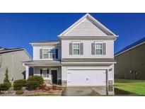 Charming two-story home with a two-car garage, well-maintained lawn, and classic curb appeal at 6821 Resting Grove Rd, Raleigh, NC 27610
