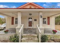Charming front porch with rustic details and inviting entrance to a cozy, single-Gathering home at 9321 Stephenson Adams Ln, Willow Springs, NC 27592