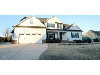Charming two-story home with a white exterior, black shutters, and an attached two car garage at 100 Vinson Park Dr, Clayton, NC 27527
