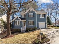 Charming two-story home with blue siding, black shutters, and a well-manicured front yard at 109 Old Dock Trl, Cary, NC 27519