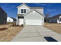 Charming two-story home featuring gray siding, a two-car garage, and a well-manicured front lawn at 1161 Centerview, Nashville, NC 27856