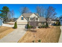 Charming two-story home featuring manicured landscaping, a spacious driveway, and an attached two-car garage at 131 Tracker Ct, Garner, NC 27529