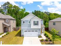 Charming two-story home with a two-car garage and manicured front lawn at 1401 Wrenn Rd, Durham, NC 27703