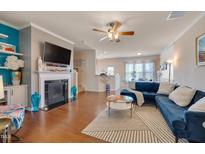 Cozy living room featuring a fireplace, modern furniture, and hardwood floors at 211 Brier Crossings Loop, Durham, NC 27703